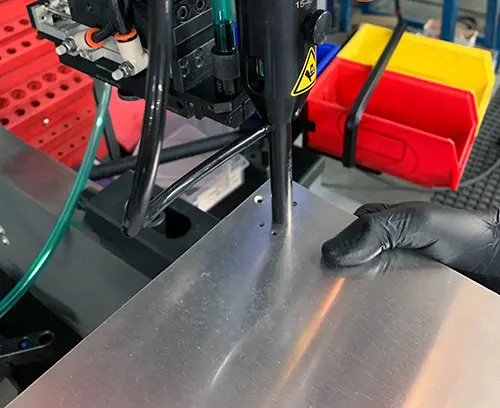 The insert is then press fitted into the panel by the machine