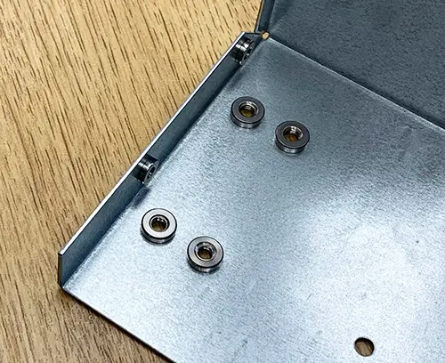 M4 self-clinch nuts (underside) fitted to panel.